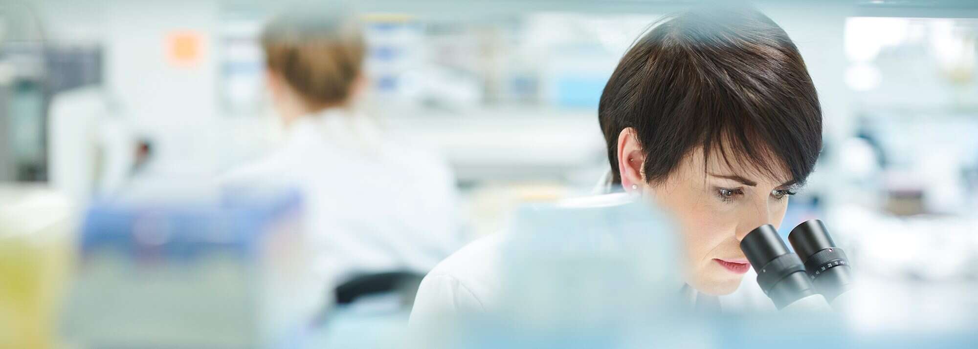 female scientist in a busy research lab